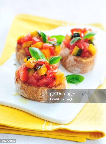 fresh tomatoes and roasted pumpkin bruschetta - pumpkin oil stock pictures, royalty-free photos & images