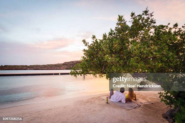 romantic sunset picnic on the beach - curaçao stock pictures, royalty-free photos & images