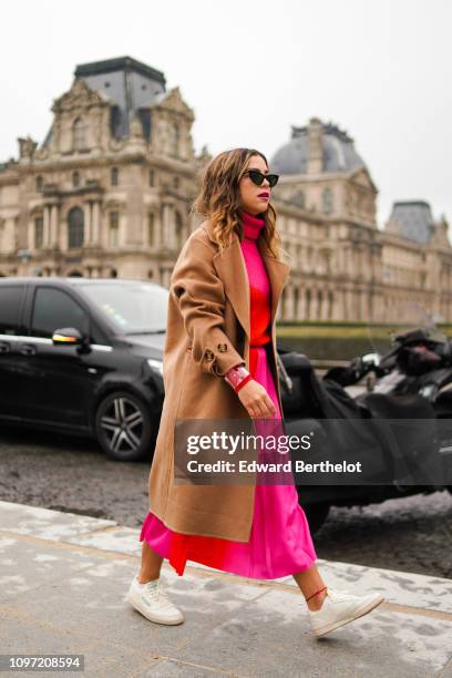 Guest wears a brown coat, a pink dress, a turtleneck wool top, outside Kenzo, during Paris Fashion Week - Menswear F/W 2019-2020, on January 20, 2019...
