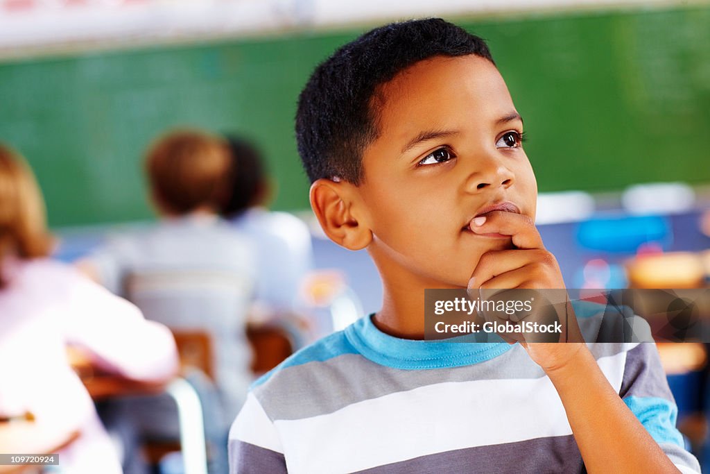 Close-up of a schoolboy thinking