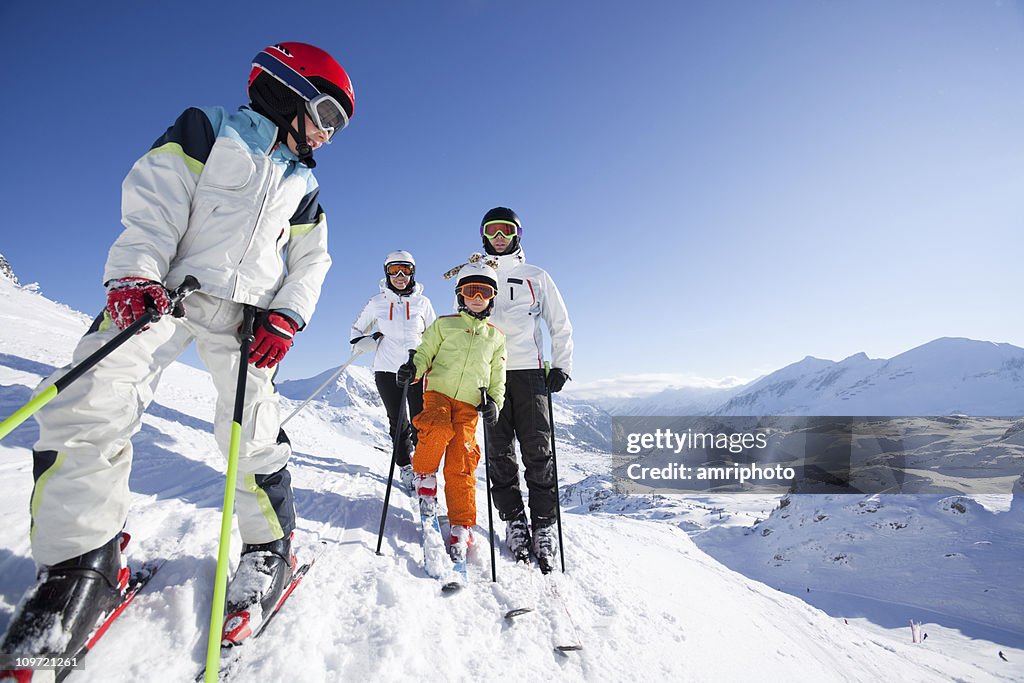 Boy in skiing outfit with his family