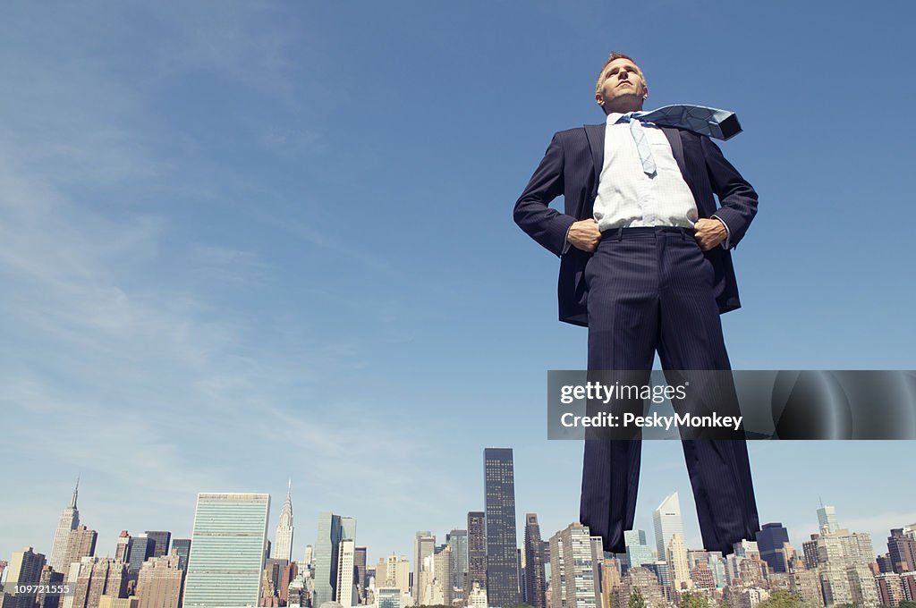 Confident Giant Businessman Standing Tall Over City Skyline
