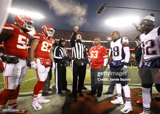 The Kansas City Chiefs and New England Patriots meet at the 50 yard line for the coin toss during the AFC Championship Game at Arrowhead Stadium on...