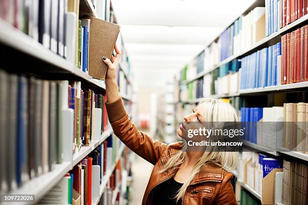 Reaching Books 309 Woman Reaching Book From Shelf Stock Photos, High-Res Pictures, and ...