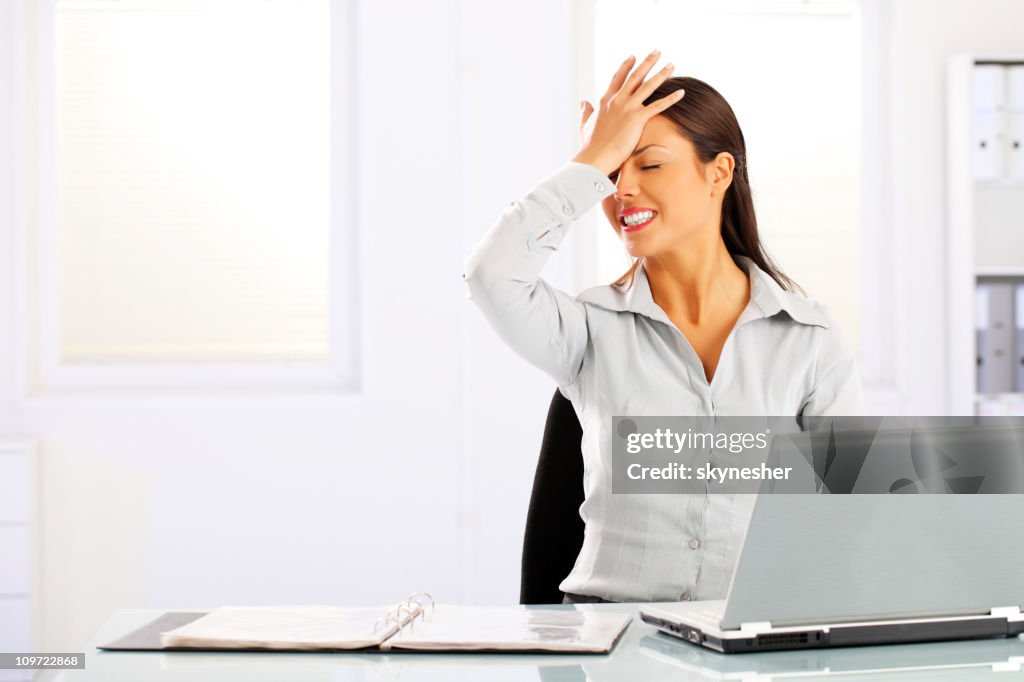 Young woman remembered something sitting in the office.