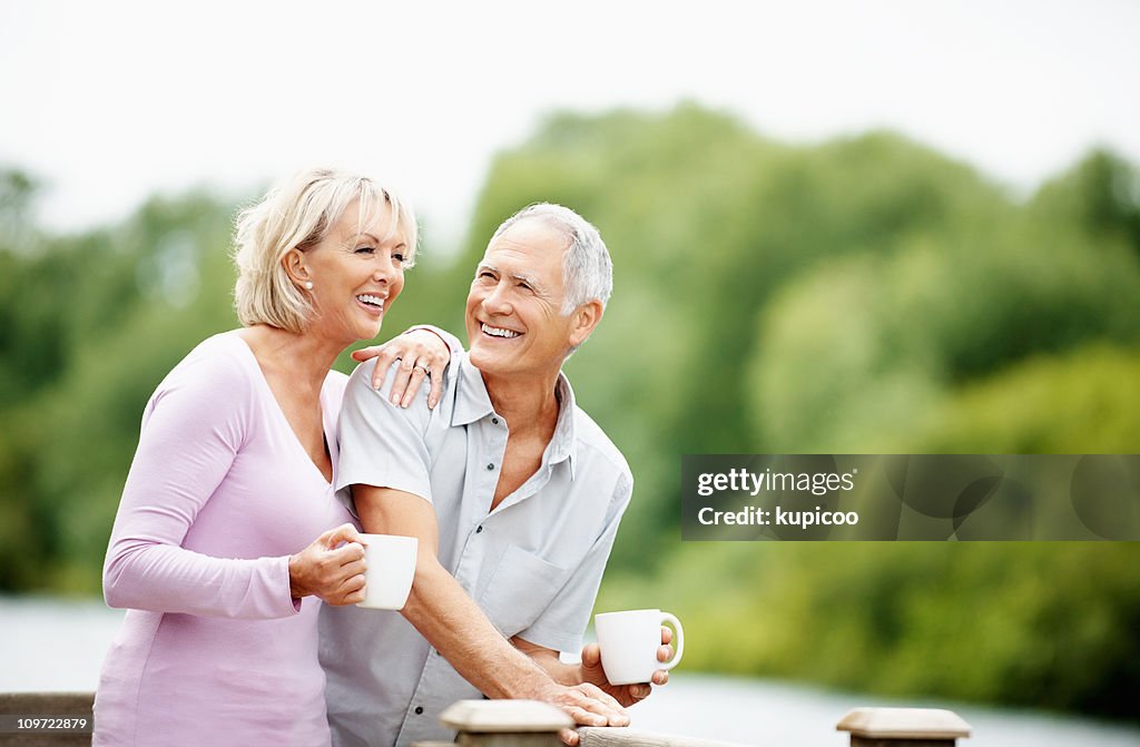 Couple spending time together, holding cup of tea or coffee