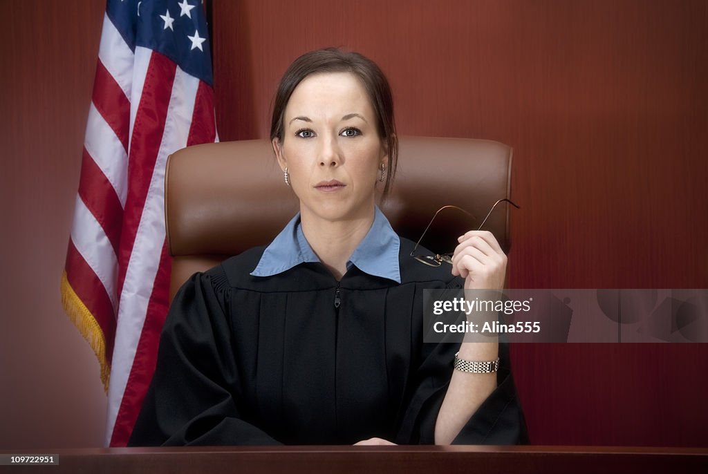 Young female judge at the bench with serious look