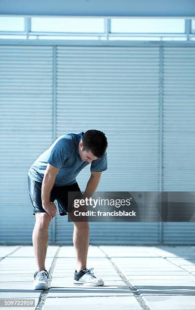 exhausted athlete catching his breath after exercise - dyspnea stock pictures, royalty-free photos & images