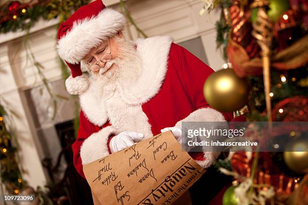 pictures of real santa claus's list he's checking twice - naughty christmas ornaments stock pictures, royalty-free photos & images