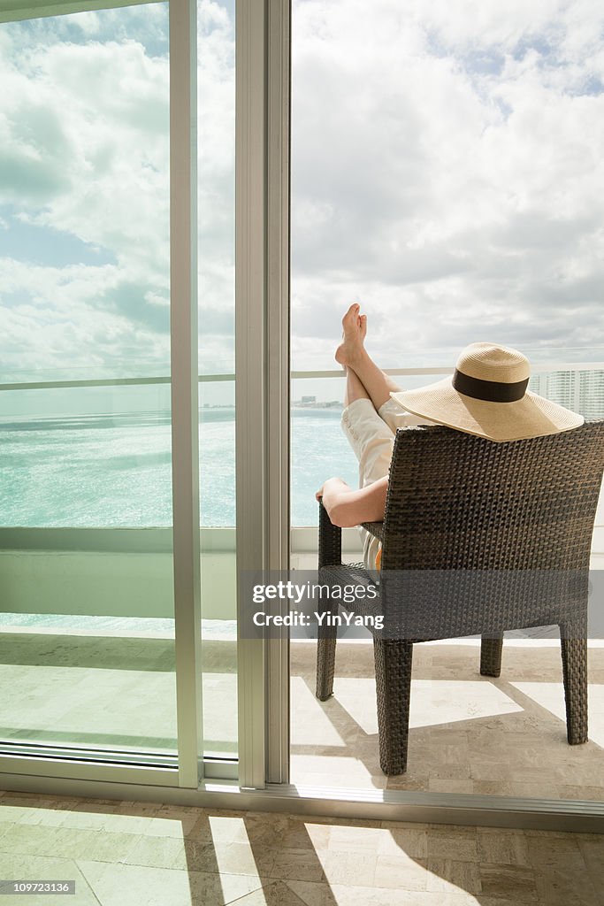 Woman Relaxing on Vacation in Hotel Balcony