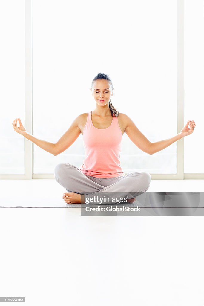 Beautiful female meditating in the lotus position