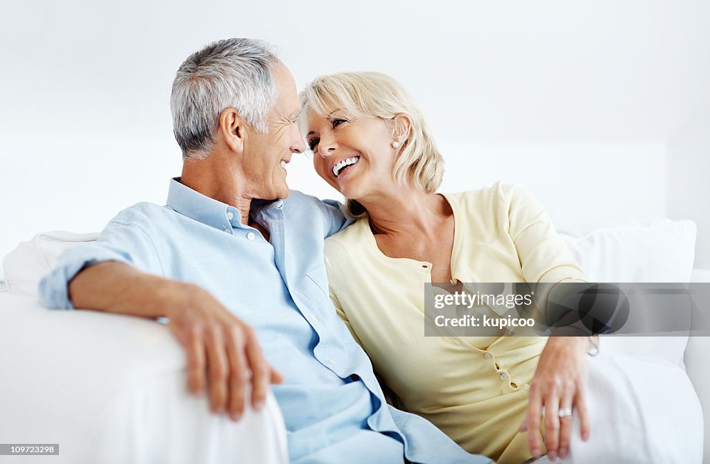 Romantic mature couple smiling while looking at each other