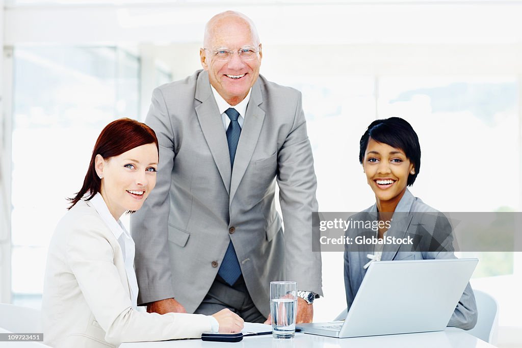 Happy successful business people working on a laptop at office