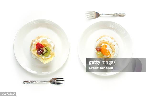 two white plates with cream puffs eclairs - cake isolated stock pictures, royalty-free photos & images