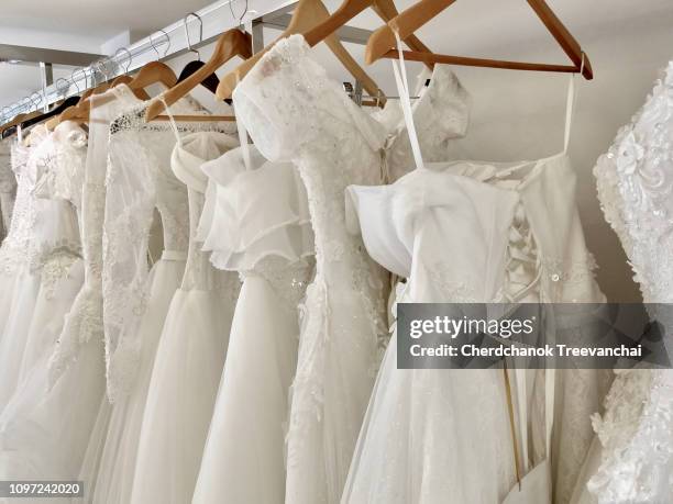 white wedding dress - wedding dress store stock pictures, royalty-free photos & images