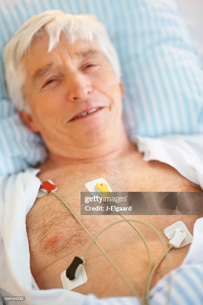 ECG transducers plugged on to a smiling patients chest