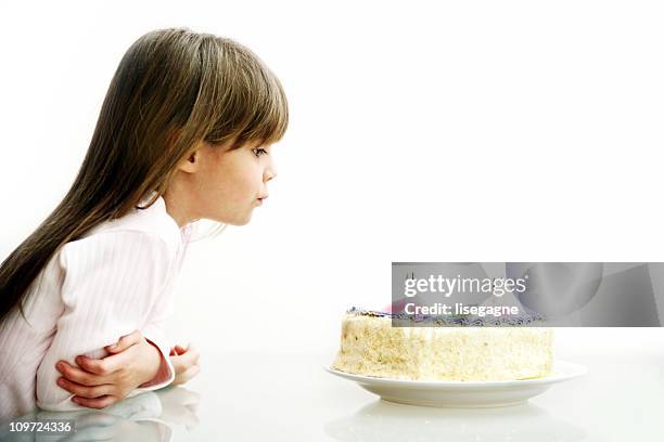 girl blowing candles - birthday cake white background stock pictures, royalty-free photos & images