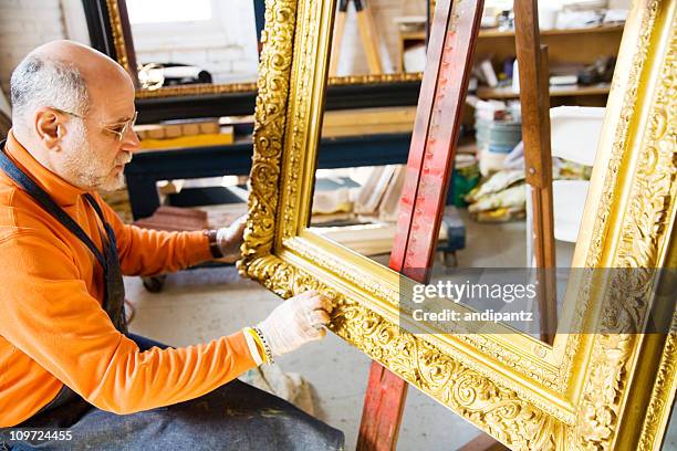 man working on antique gold picture frame - restoring art stock pictures, royalty-free photos & images