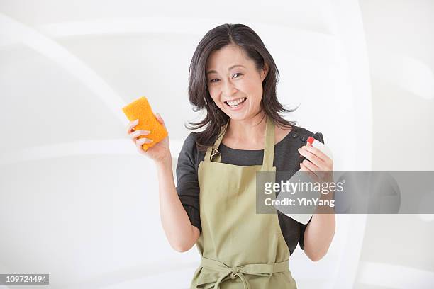 japanese woman cleaning house, holding a sponge and spray bottle - only japanese stock pictures, royalty-free photos & images