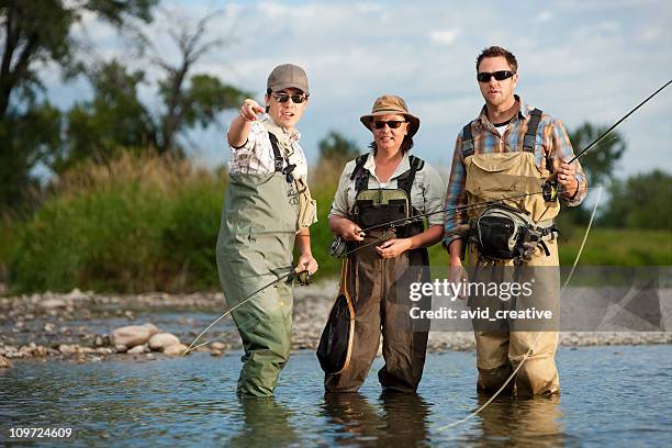 fly fishing guide teaching couple - creative fishing stock pictures, royalty-free photos & images