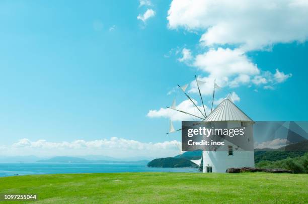 wind mill under blue sky - seto inland sea stock pictures, royalty-free photos & images