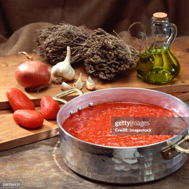 a dish of tomato sauce on a hob - plum tomato stock pictures, royalty-free photos & images