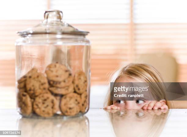 peeking over the counter - child cookie jar stockfoto's en -beelden
