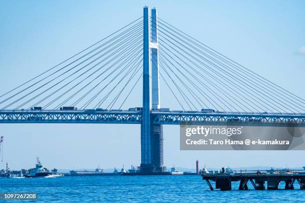 port of yokohama and yokohama bay bridge in yokohama in kanagawa prefecture in japan - bay bridge fotografías e imágenes de stock