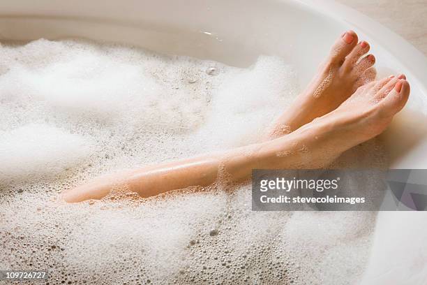 woman's legs & feet in bubble bath - taking a bath stock pictures, royalty-free photos & images