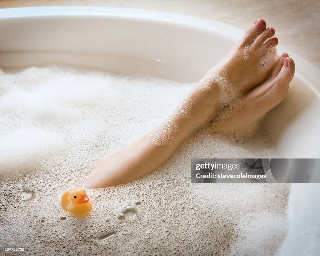 Woman's Legs in Bubble Bath with Ducky