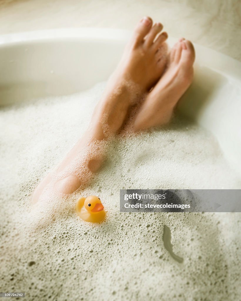 Female's Legs in Bubblebath with Yellow Rubber Ducky