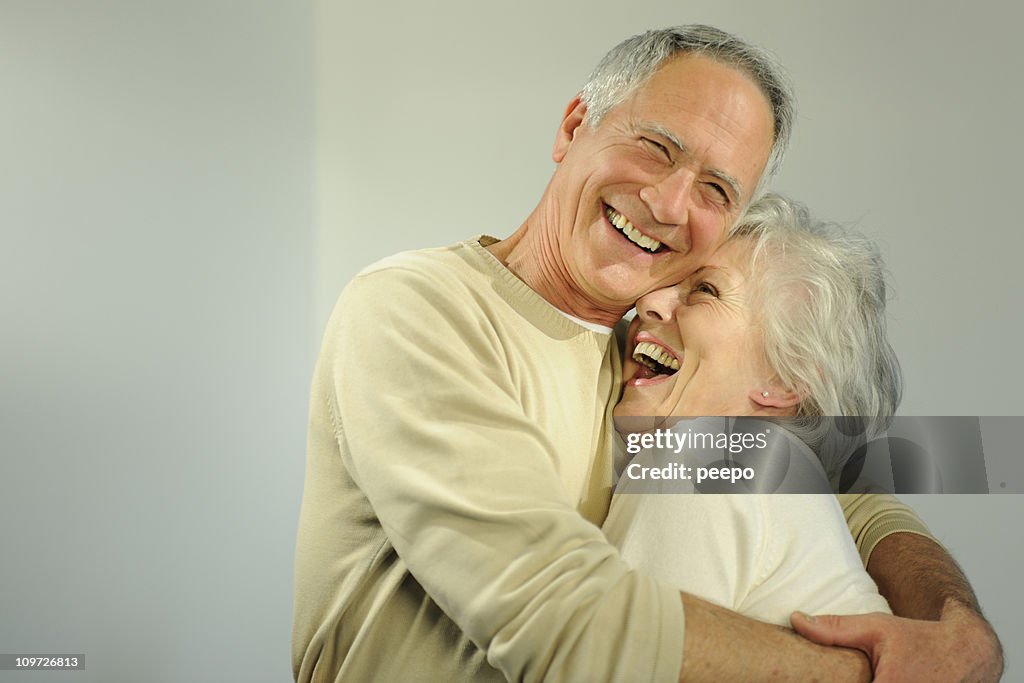 Mature senior couple hugging.