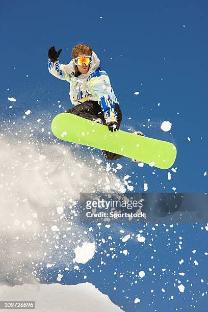 snowboarder suspended high in air - snowboard jump bildbanksfoton och bilder
