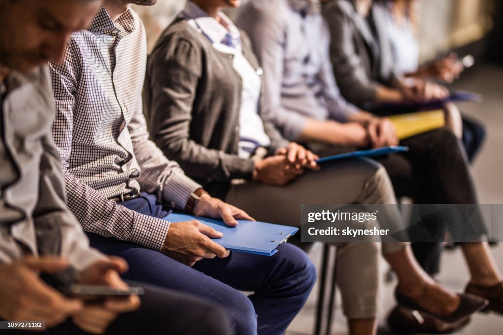 Group of unrecognizable candidates waiting for a job interview.