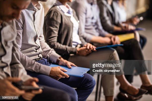 group of unrecognizable candidates waiting for a job interview. - interview event stock pictures, royalty-free photos & images