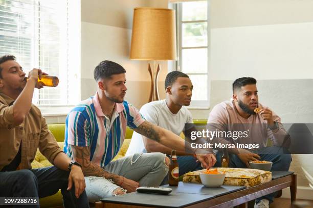 soccer fans watching match on tv at home - day of rage grips jerusalem and west bank stockfoto's en -beelden