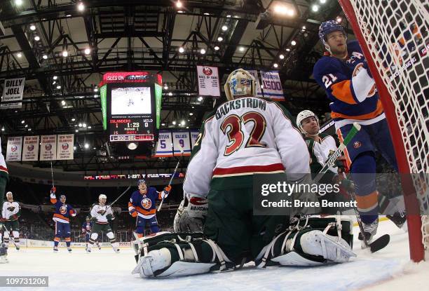 Frans Nielsen, Michael Grabner, and Kyle Okposo of the New York Islanders celebrate Okposo's first period goal against the Minnesota Wild at the...