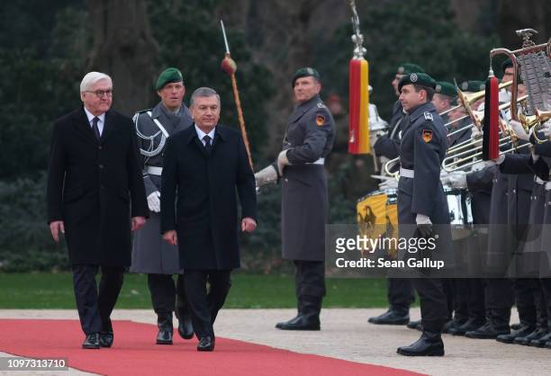 German President Frank-Walter Steinmeier and Uzbek President Shavkat Mirziyoyev review a guard of honor upon Mirziyoyev's arrival at Schloss Bellevue...