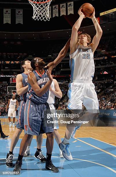 Timofey Mozgoz of the Denver Nuggets puts up a shot against D.J. White of the Charlotte Bobcats at the Pepsi Center on March 2, 2011 in Denver,...