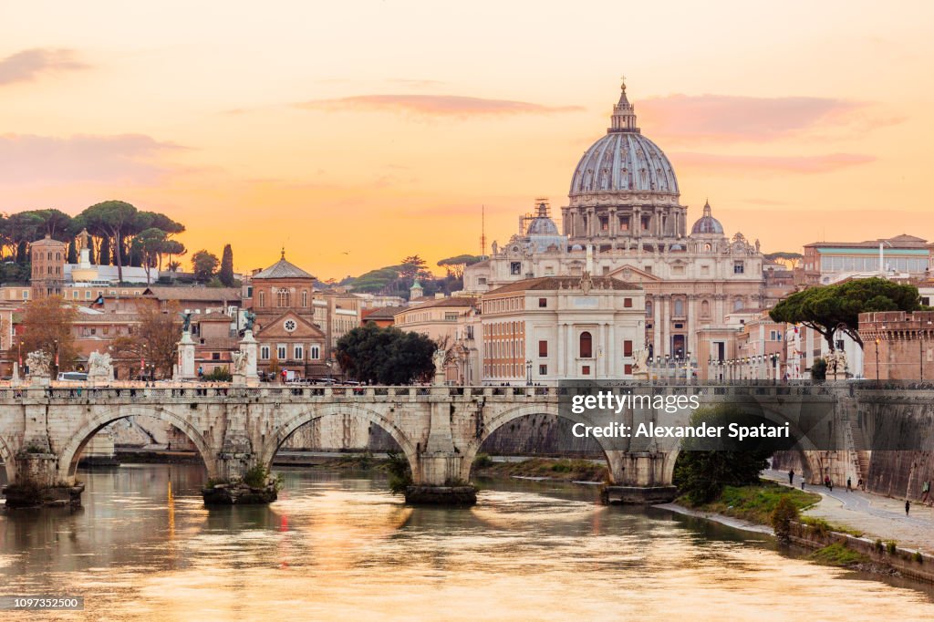 Rome skyline at sunset with Tiber river and St. Peter's Basilica, Italy