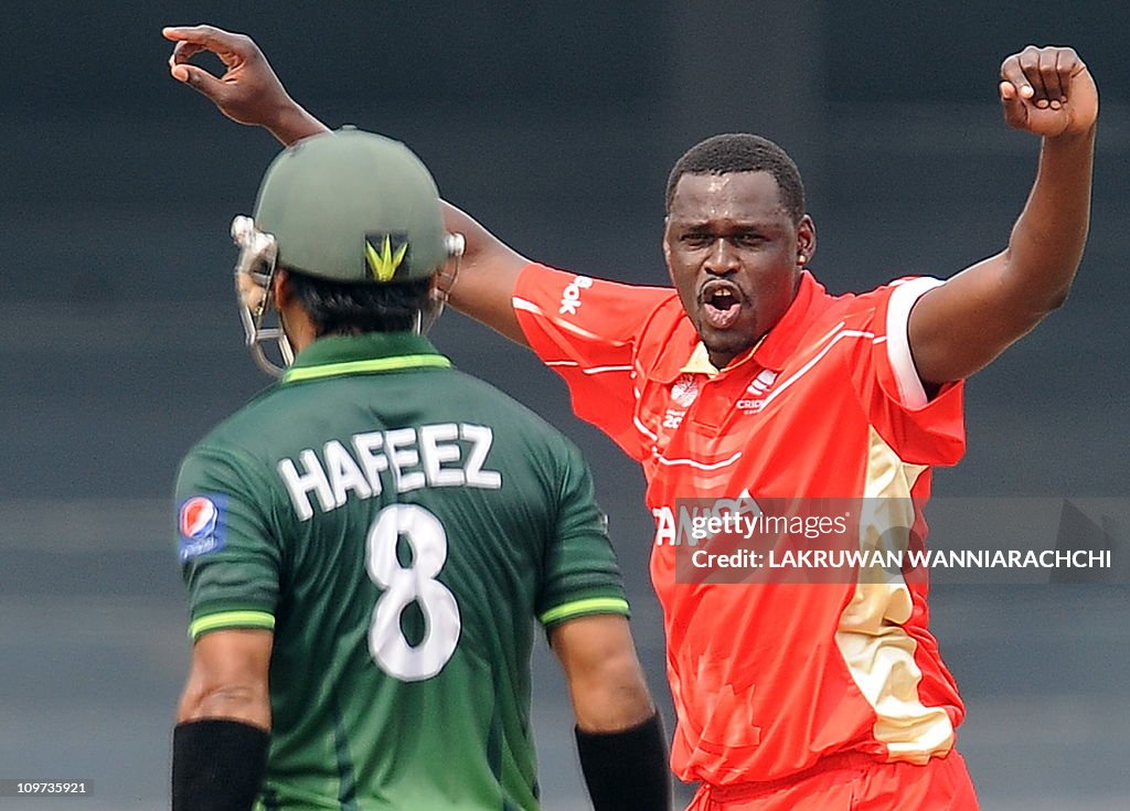 Canadian cricketer Henry Osinde (R) cele