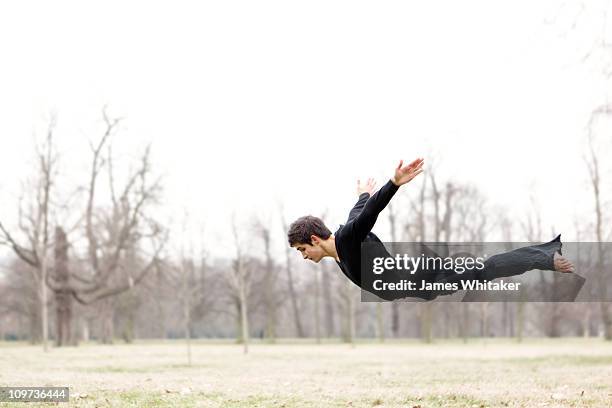 a dancer flies in the park - man flying stockfoto's en -beelden