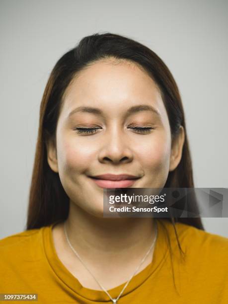 real malaysian young woman with happy expression and eyes closed - beautiful filipino women stock pictures, royalty-free photos & images