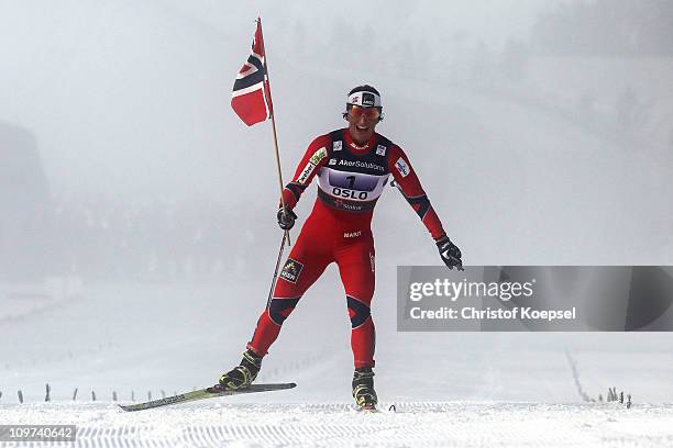 Marit Bjoergen of Norway celebrates as she crosses the finish line to win the gold medal in the Ladies Cross Country 4x5km Relay race during the FIS...
