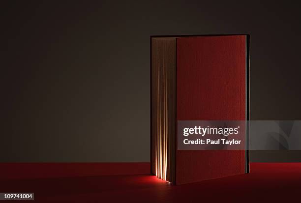 book glowing from within - glowing book stock pictures, royalty-free photos & images