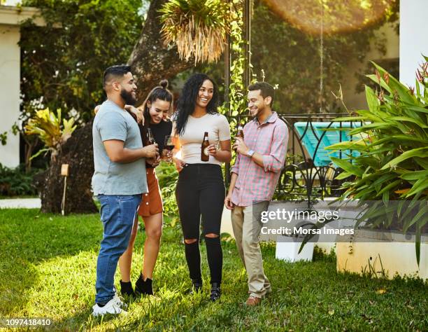 smiling young friends enjoying party in backyard - fiesta de jardín fotografías e imágenes de stock