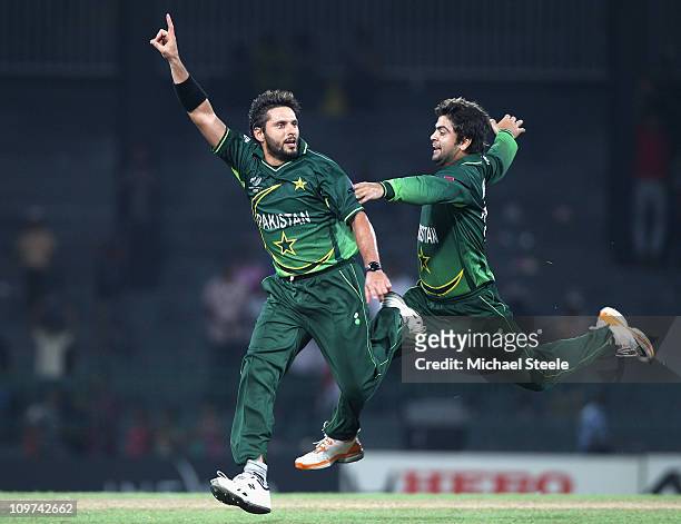 Shahid Afridi of Pakistan celebrates with Ahmed Shehzad after taking the wicket of Harvir Baidwan during the Canada v Pakistan 2011 ICC World Cup...