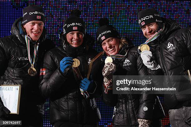 Tarjei Boe of Norway and his team mates Ann Kristin Aafeldt , Tora Berger and Ole Einar Bjoerndalen pose with their gold medal of the mixed relay...
