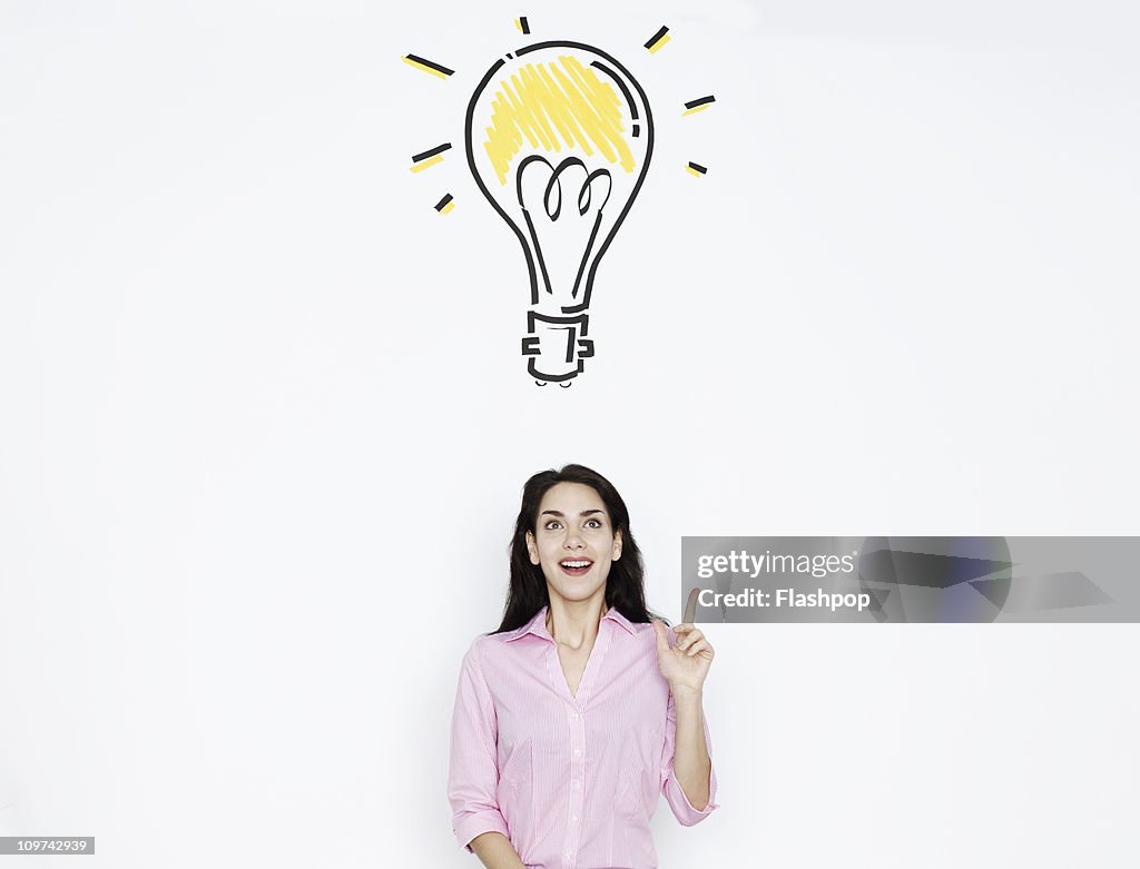 Woman with drawing of lightbulb over her head