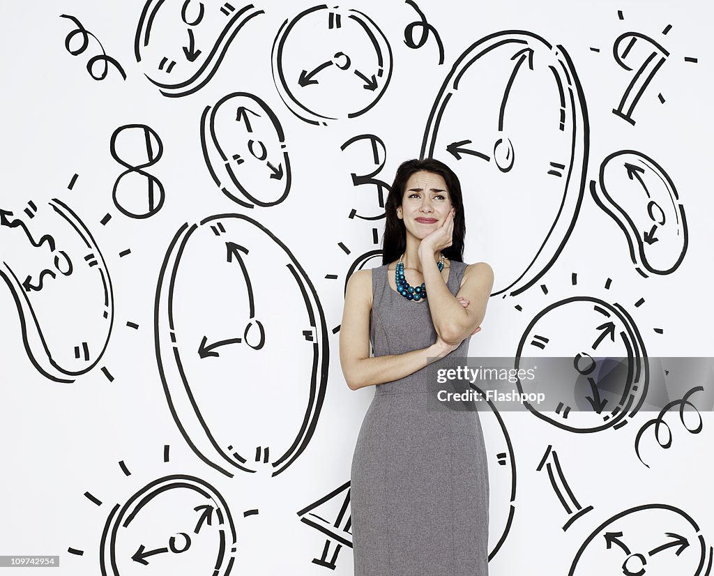 Business woman surrounded by clocks